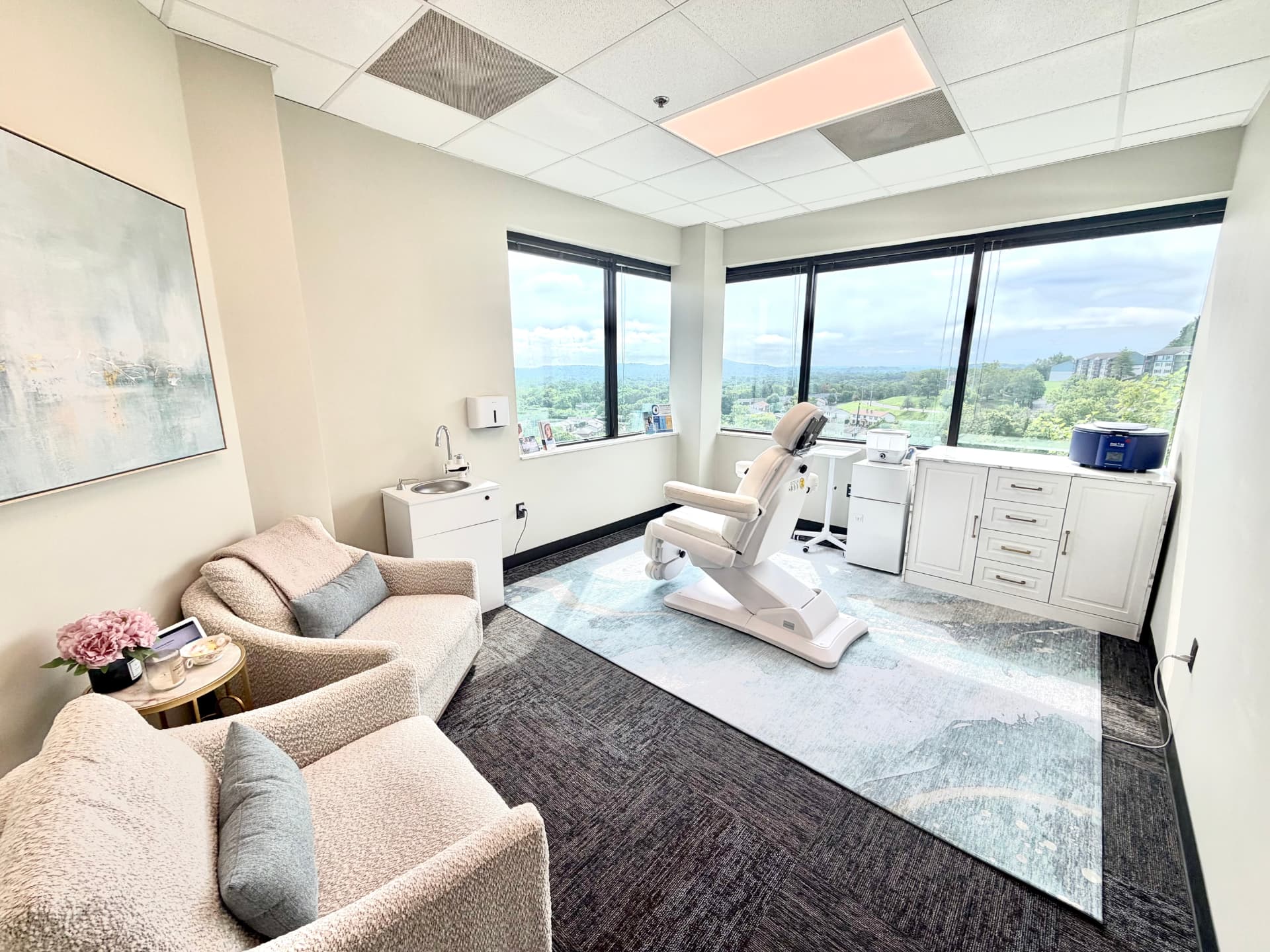 The Vital RN treatment room in Brentwood with seating, medical chair, and scenic windows